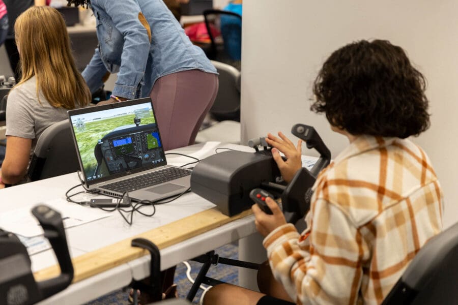 A participant using the flight simulator at Girls in Aviation Day 2024